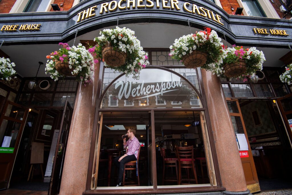 Wetherspoon cuts plans for more pubs as sales fall