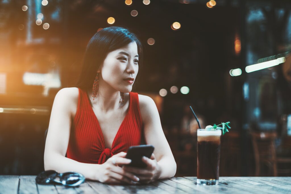 An Asian female in an outdoor bar